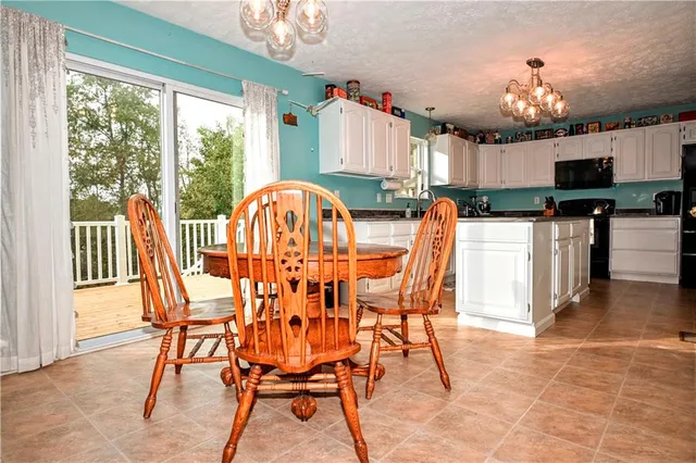 a view of a dining room with furniture and chandelier