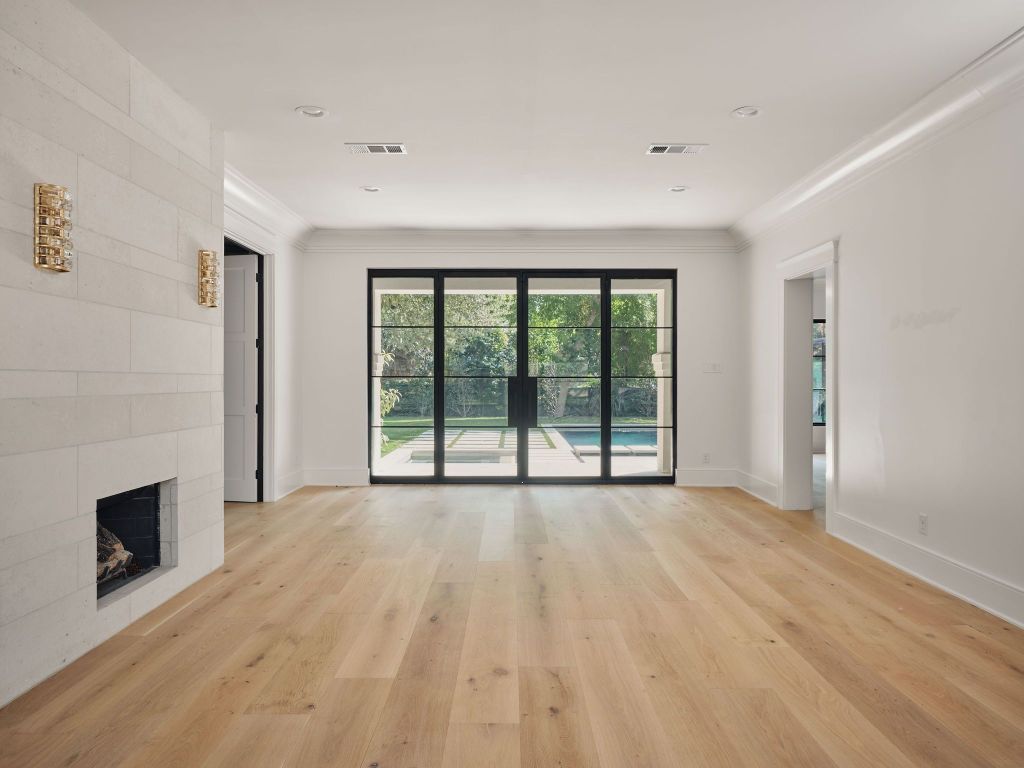 13 Niles Road Austin, TX 78703 - Photo 18 of 40 a view of an empty room with a fireplace and a window