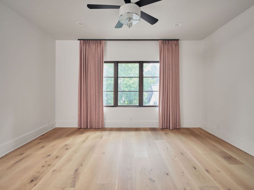 13 Niles Road Austin, TX 78703 - Photo 31 of 40 an empty room with wooden floor chandelier fan and windows