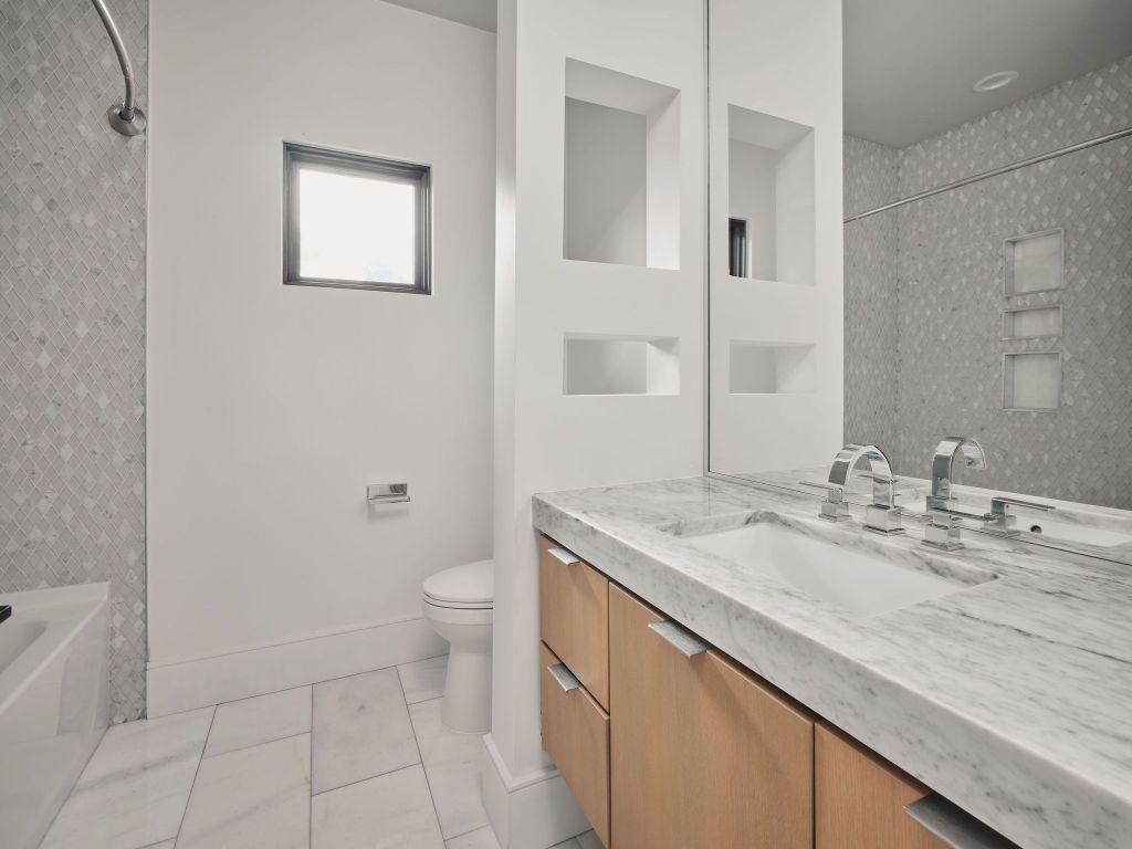 13 Niles Road Austin, TX 78703 - Photo 32 of 40 a bathroom with a granite countertop sink a toilet and a mirror