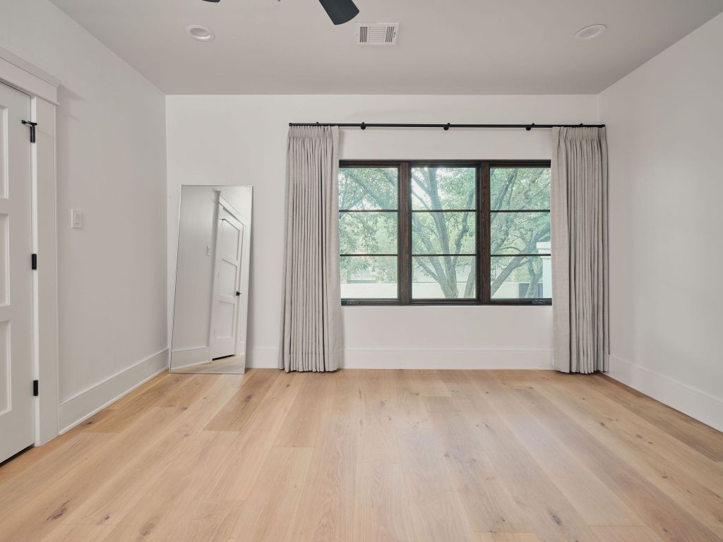 13 Niles Road Austin, TX 78703 - Photo 33 of 40 an empty room with wooden floor and windows