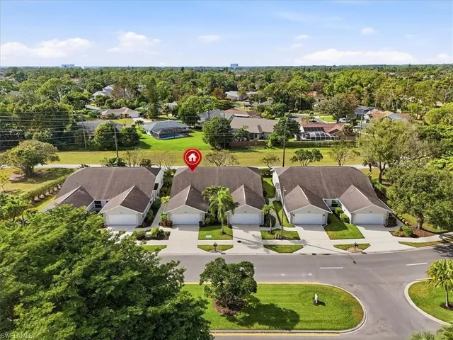 an aerial view of a house with garden space and lake view