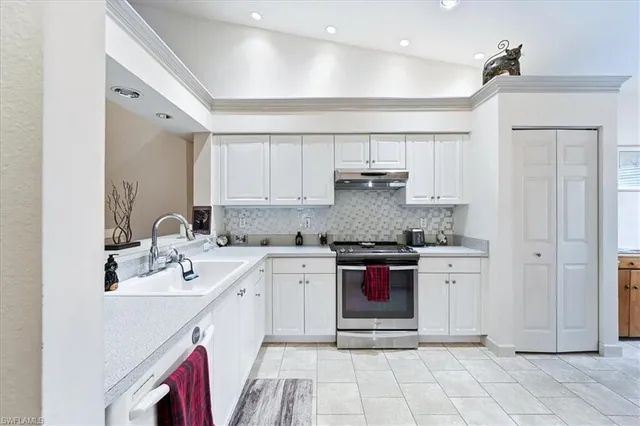 a kitchen with stainless steel appliances granite countertop a sink and cabinets