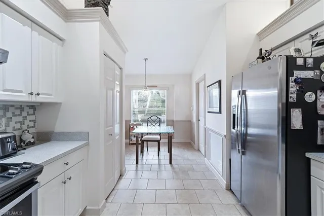 a kitchen with stainless steel appliances a refrigerator and a stove