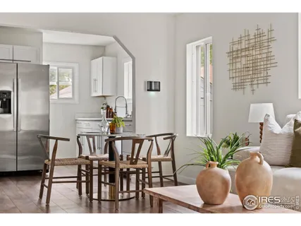 a view of a dining room with furniture and a potted plant
