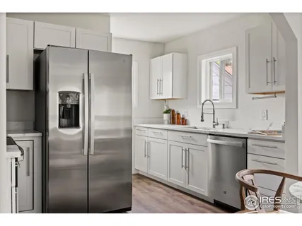 a kitchen with stainless steel appliances a refrigerator sink and cabinets