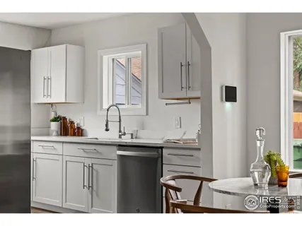 a kitchen with cabinets appliances and a sink
