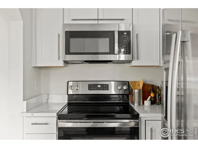 a kitchen with appliances and cabinets