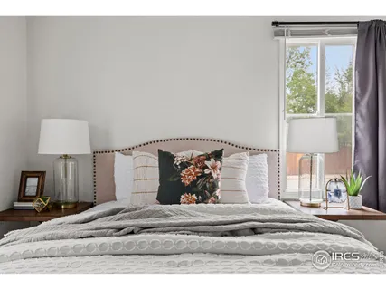 a view of a bedroom with a bed and a lamp