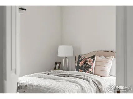 a bed room with a bed and a lamp