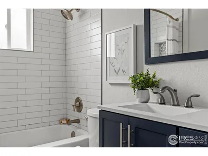 a bathroom with a sink a mirror and shower