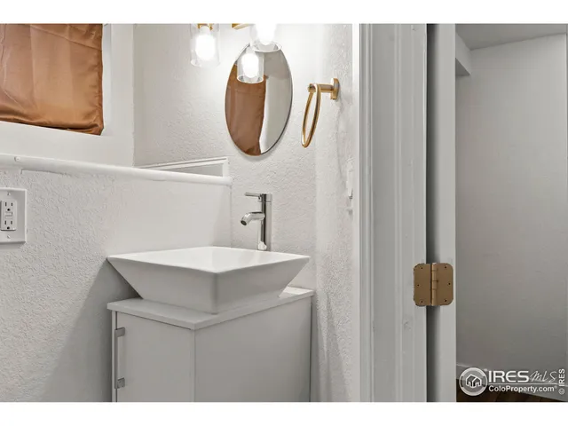 a bathroom with a sink vanity and a mirror