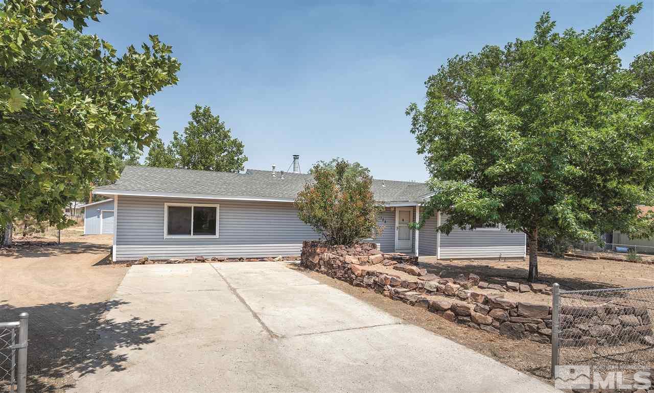 155 Roughing It Road Dayton, NV 89403 - Photo 1 of 1 a backyard of a house with table and chairs