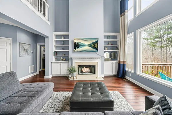a living room with furniture fireplace and flat screen tv