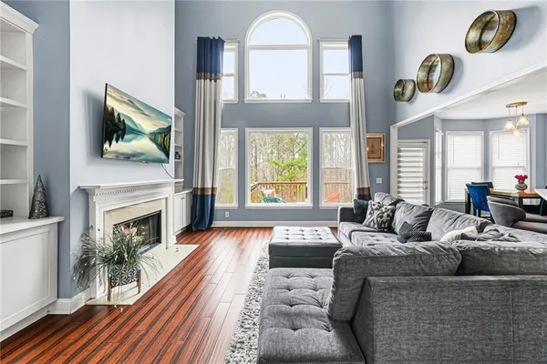 a living room with furniture a fireplace and a flat screen tv