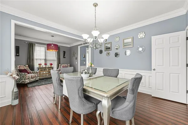 a view of a dining room with furniture and wooden floor