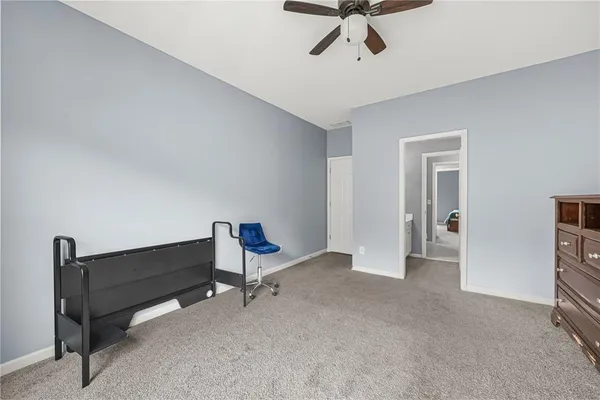 a view of room with furniture and a ceiling fan