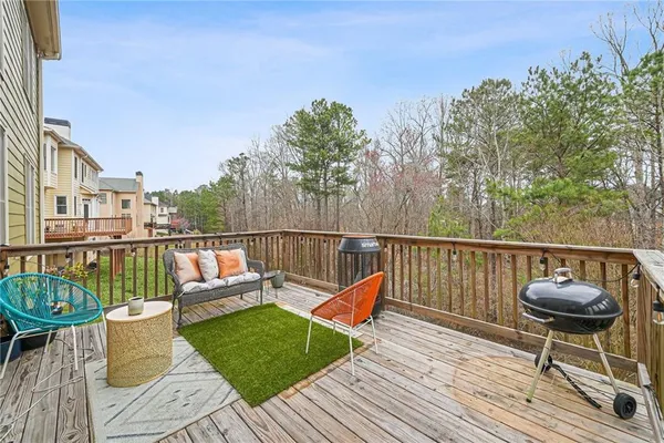a balcony with wooden floor and a potted plant
