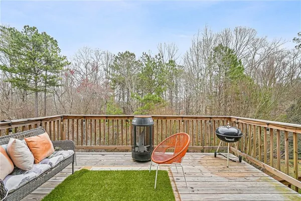a view of a chair and tables in the back yard of the house