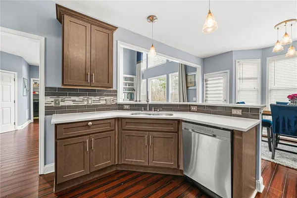 a kitchen with a sink stove and cabinets