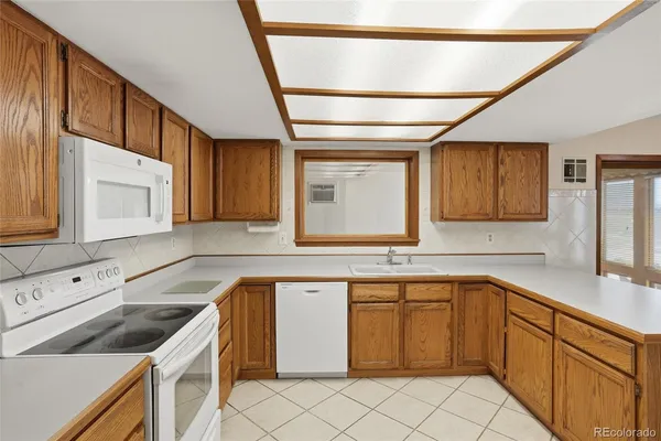a kitchen that has a sink and a stove in it