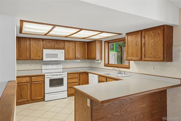 a kitchen that has a sink and a stove in it