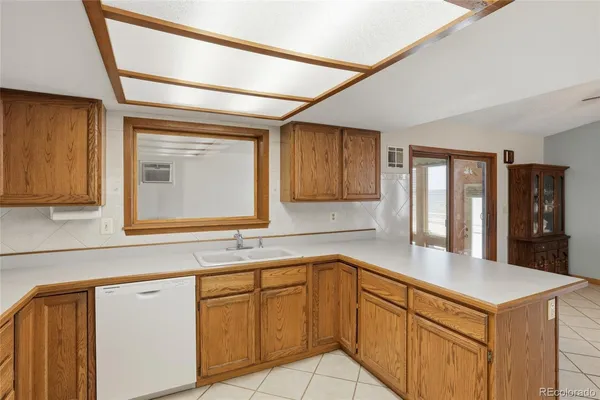 a kitchen with stainless steel appliances granite countertop a sink and cabinets with wooden floor
