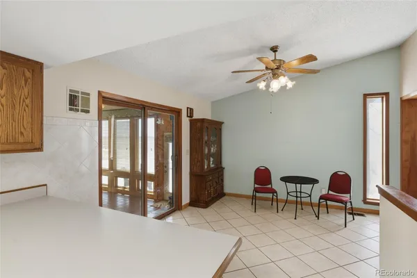 a workspace with chandelier fan and a window