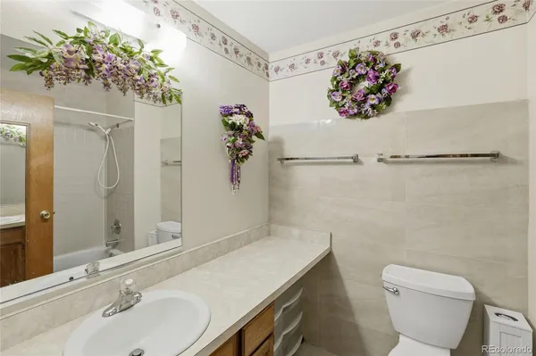 a bathroom with a sink mirror and toilet