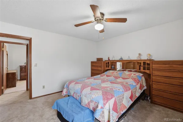 a bedroom with a bed and ceiling fan
