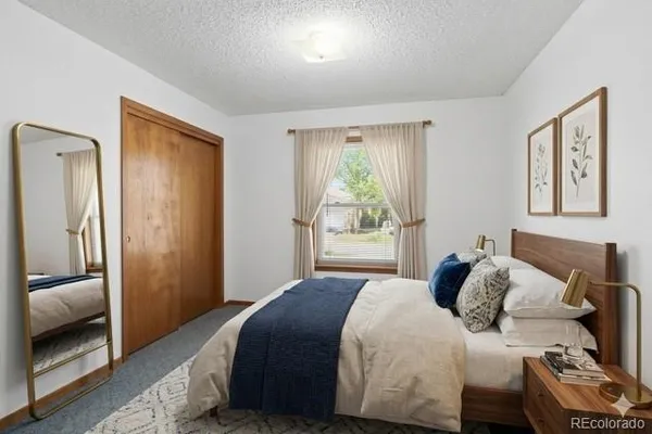 a bedroom with a bed and a painting on the wall