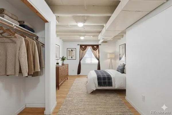 a hallway with a couch and a walk in closet