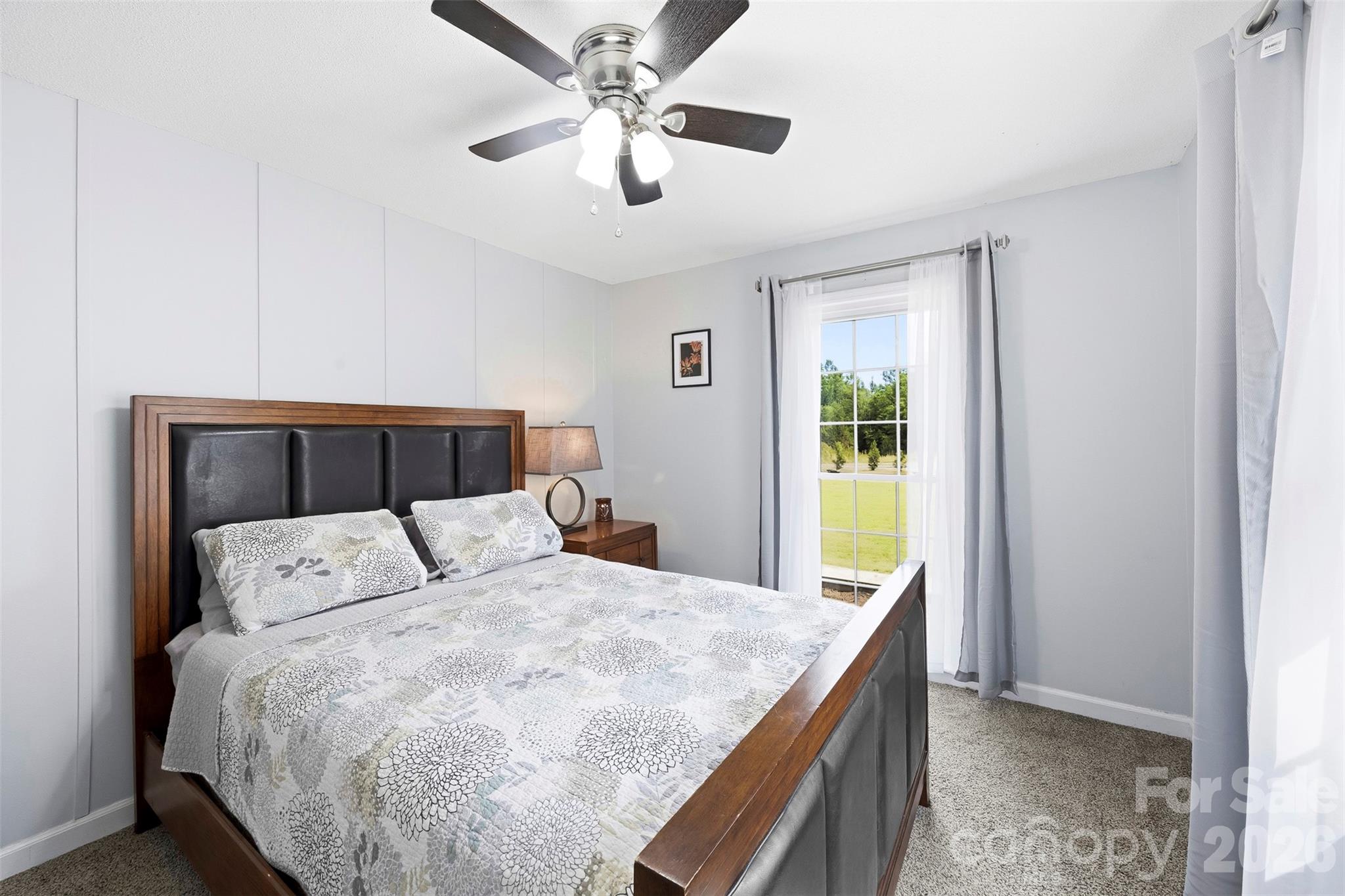 10919 Harrisburg Road Fort Mill, SC 29707 - Photo 25 of 43 a bedroom with a large bed and a chandelier