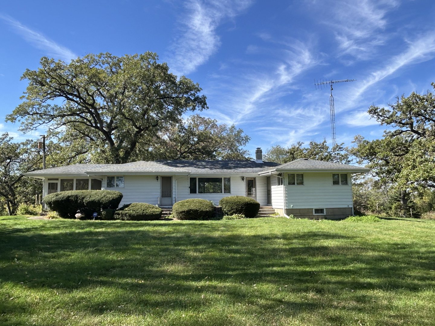 a front view of house with yard and green space