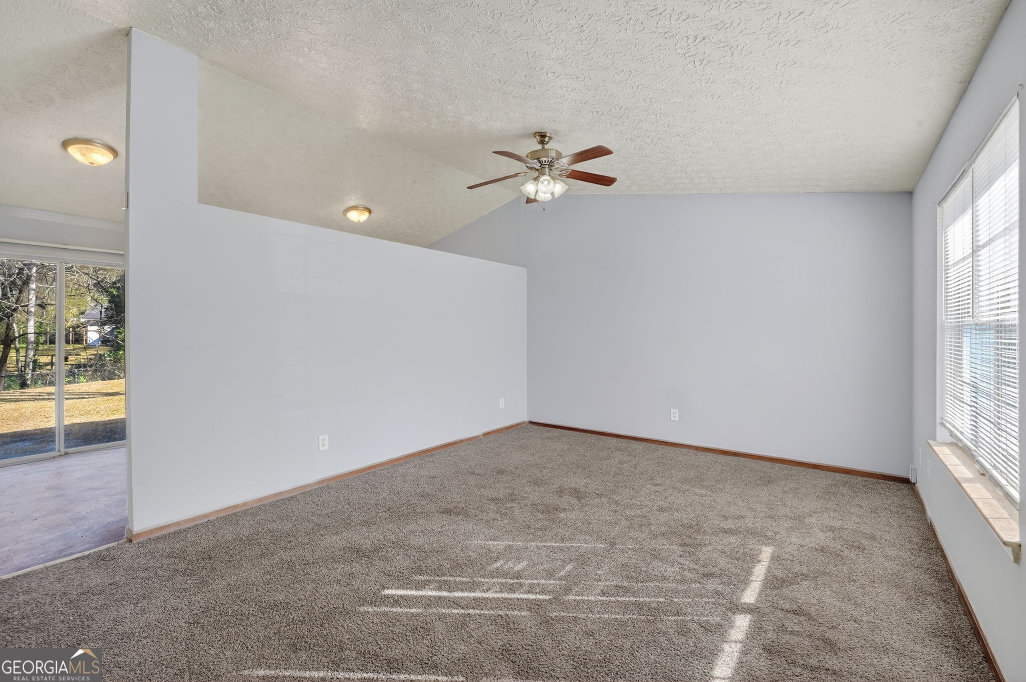 10248 Briarbay Loop Jonesboro, GA 30238 - Photo 15 of 31 an empty room with windows and fan
