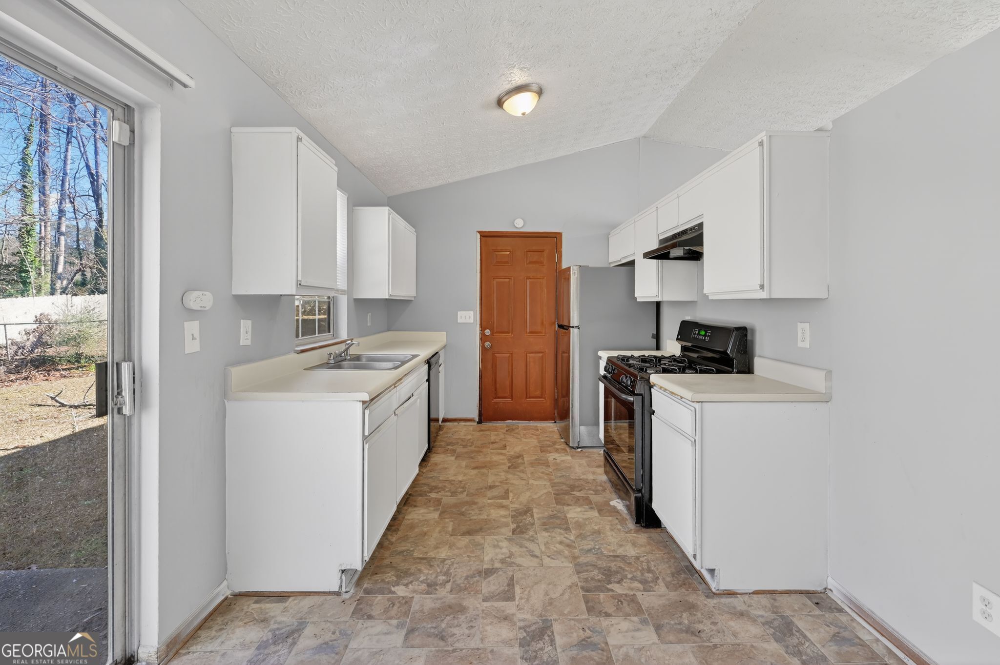 10248 Briarbay Loop Jonesboro, GA 30238 - Photo 18 of 31 a kitchen with a white stove top oven and white cabinets