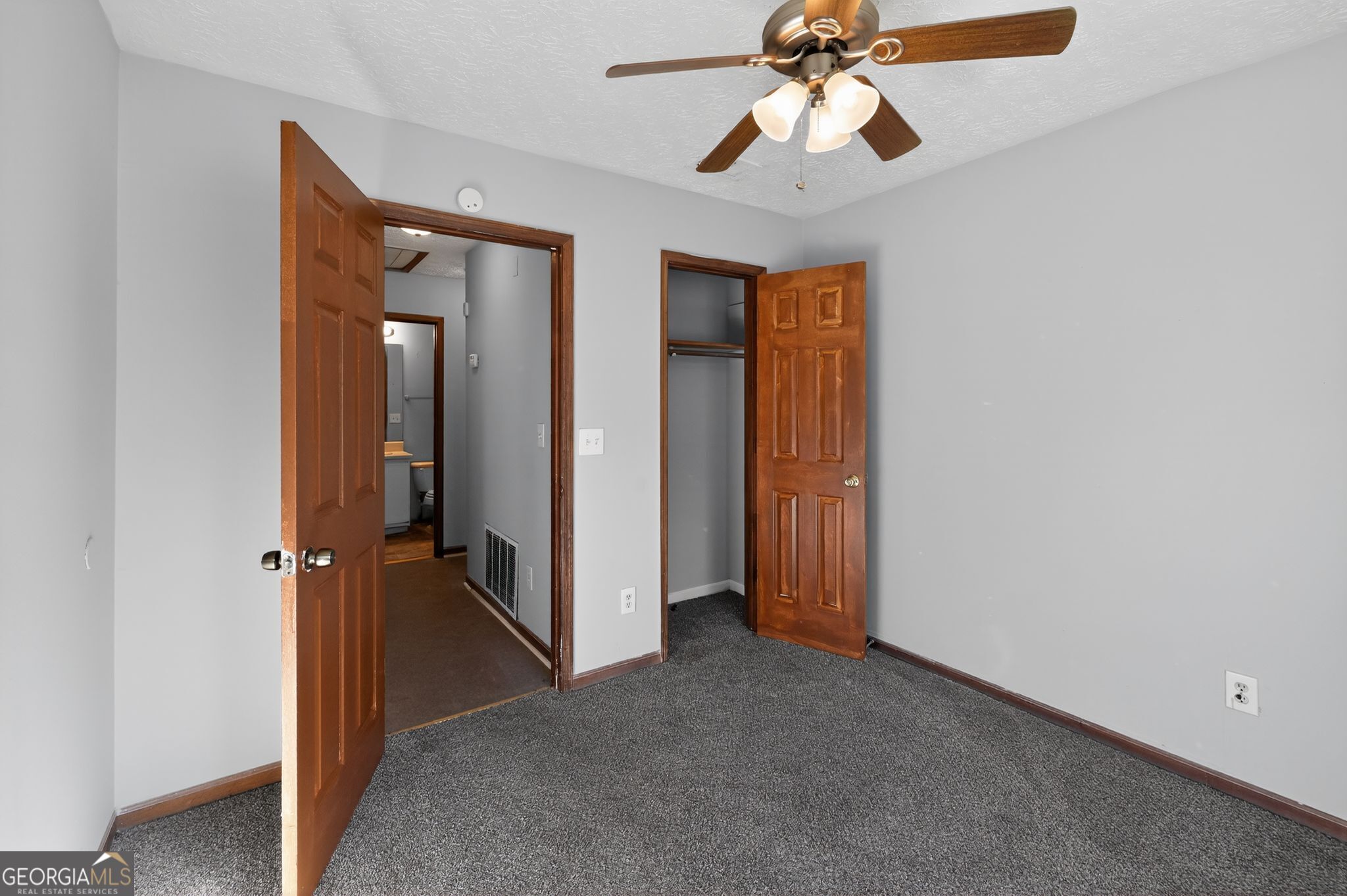 10248 Briarbay Loop Jonesboro, GA 30238 - Photo 19 of 31 an empty room with closet and a chandelier fan