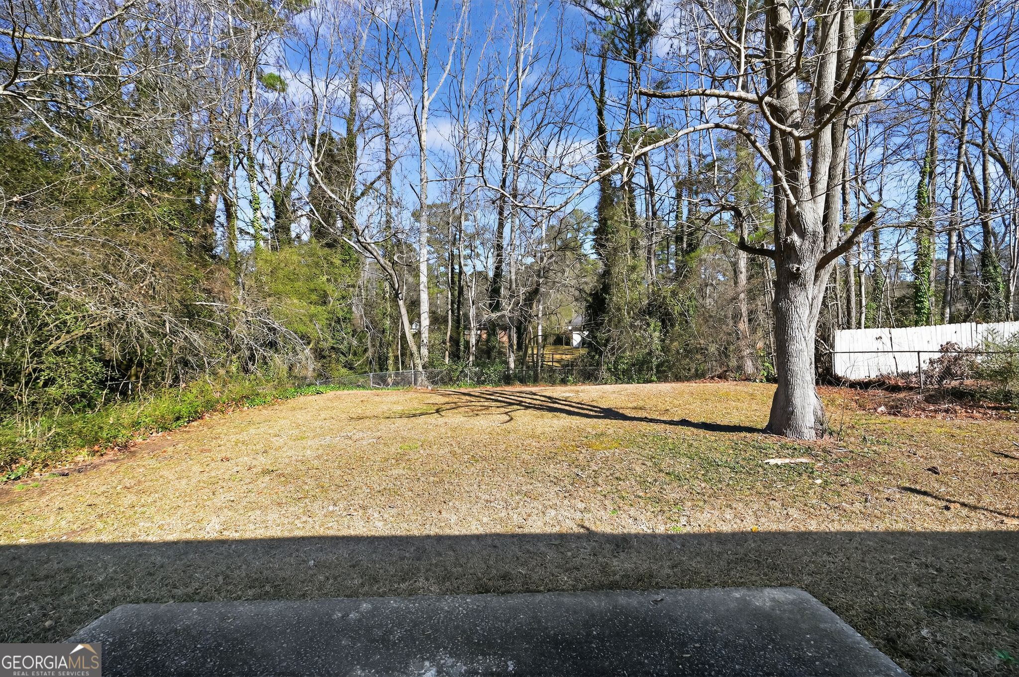 10248 Briarbay Loop Jonesboro, GA 30238 - Photo 28 of 31 a view of a yard with wooden fence