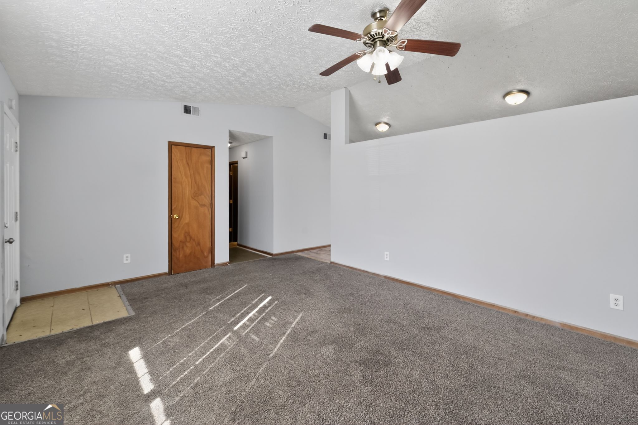 10248 Briarbay Loop Jonesboro, GA 30238 - Photo 6 of 31 a view of a big room with a ceiling fan and a window