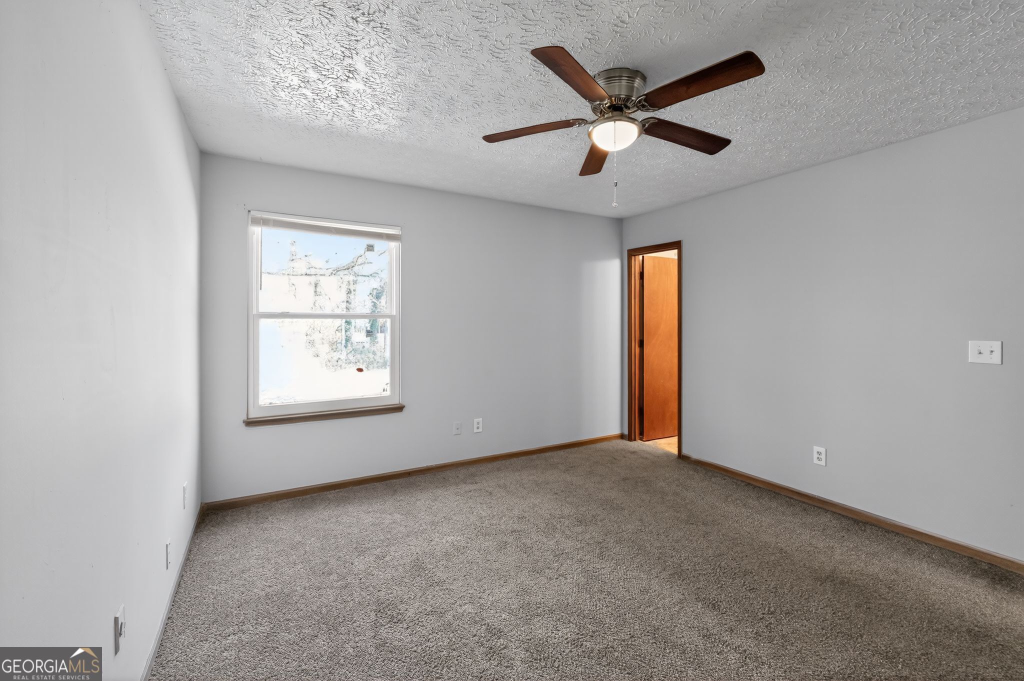 10248 Briarbay Loop Jonesboro, GA 30238 - Photo 7 of 31 an empty room with ceiling fan and windows