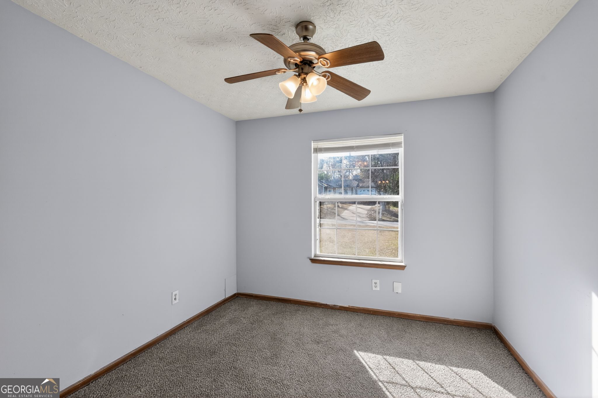 10248 Briarbay Loop Jonesboro, GA 30238 - Photo 9 of 31 an empty room with a window and a ceiling fan