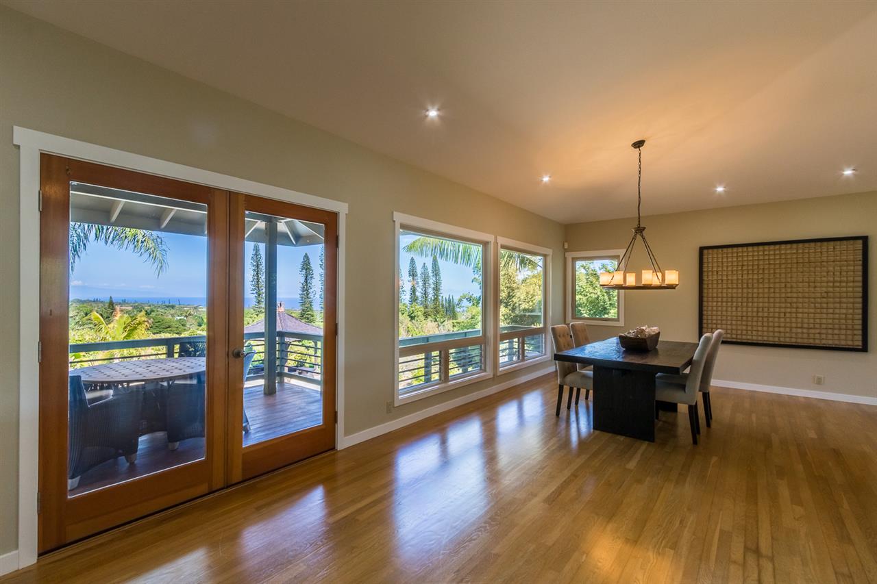 195 Mauu Place Haiku, HI 96708 - Photo 12 of 30 a dining room with wooden floor a chandelier a glass table and chairs