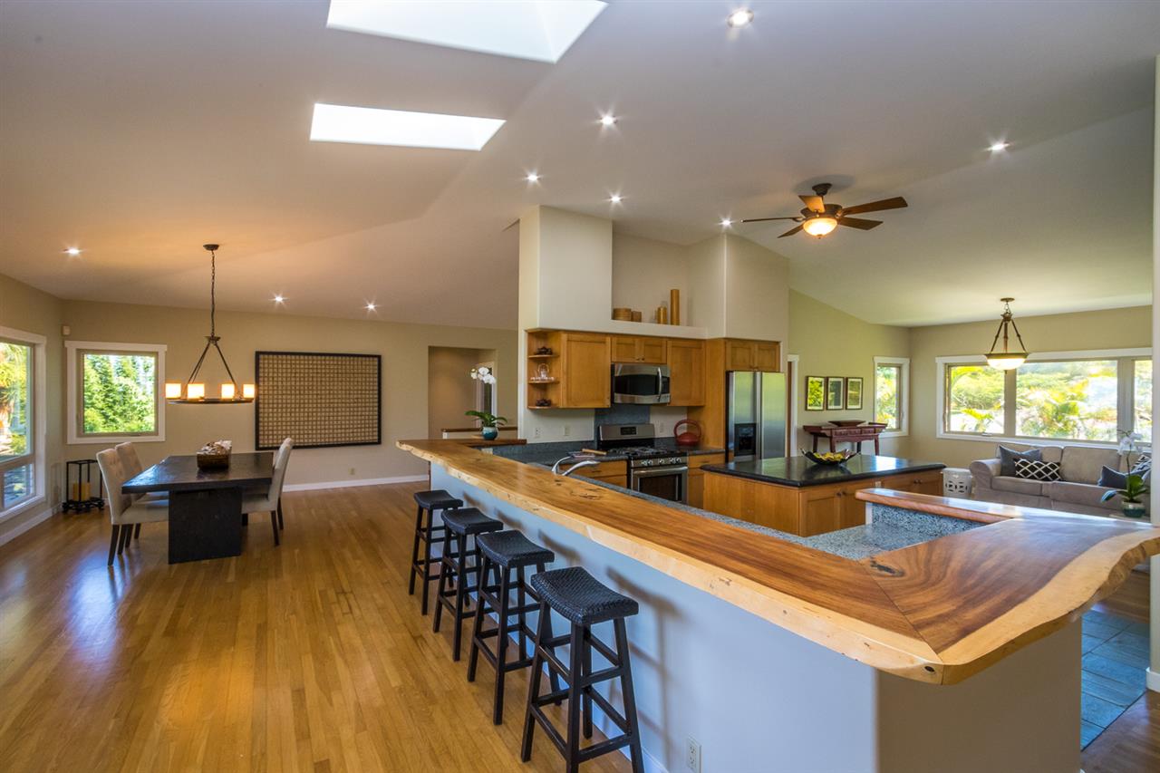 195 Mauu Place Haiku, HI 96708 - Photo 14 of 30 a view of a dining room and livingroom with furniture wooden floor a chandelier