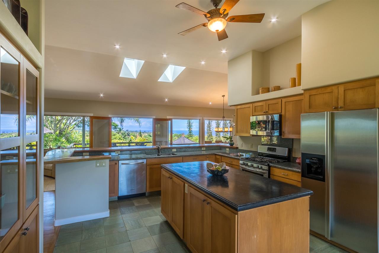 195 Mauu Place Haiku, HI 96708 - Photo 15 of 30 a kitchen with stainless steel appliances granite countertop a sink and a refrigerator