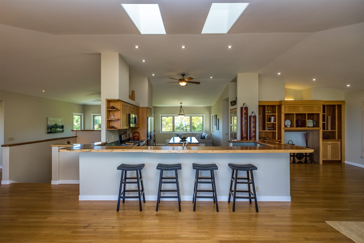 195 Mauu Place Haiku, HI 96708 - Photo 16 of 30 a kitchen with stainless steel appliances granite countertop a stove top oven a sink a dining table and chairs