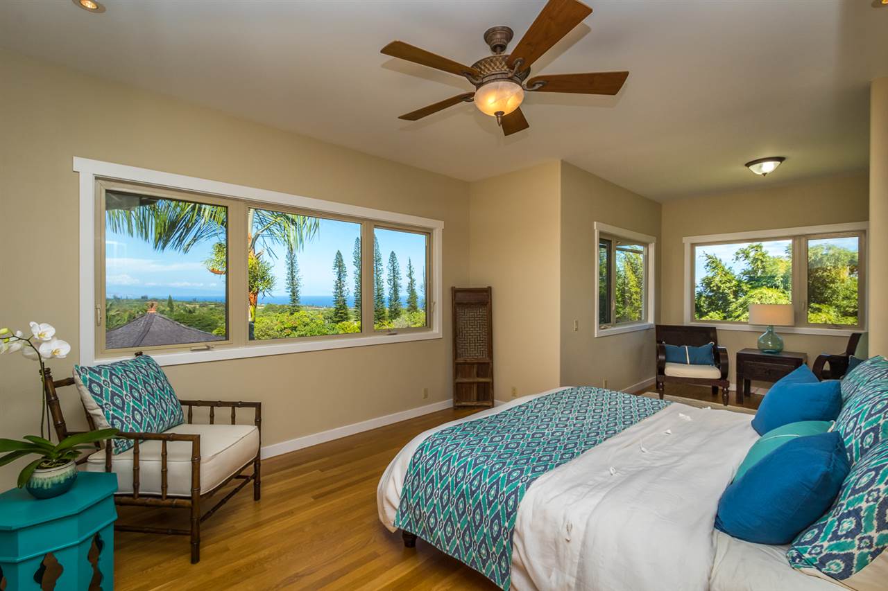 195 Mauu Place Haiku, HI 96708 - Photo 17 of 30 a bedroom with a bed and a large window