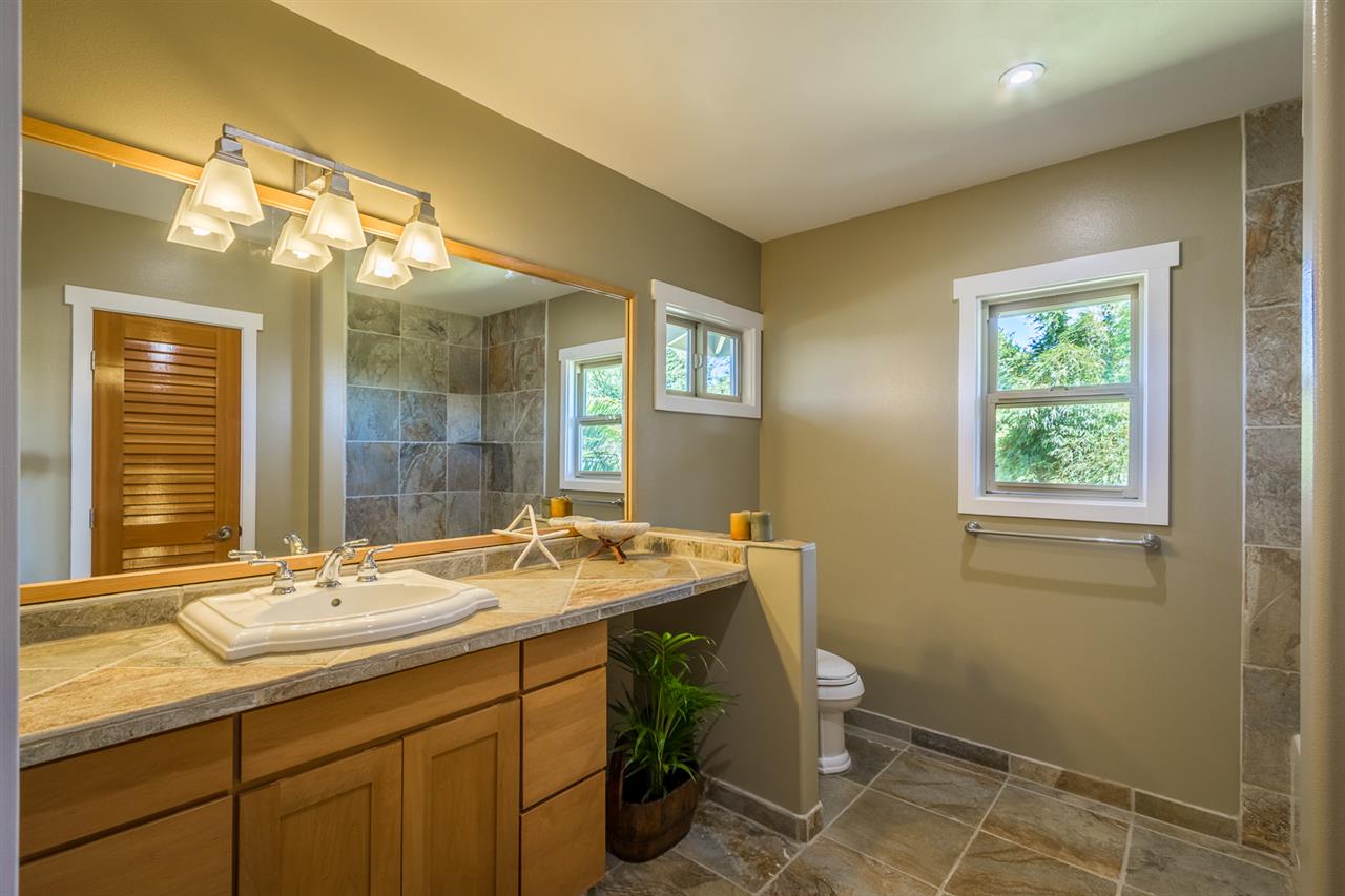 195 Mauu Place Haiku, HI 96708 - Photo 22 of 30 a bathroom with a sink a toilet and a mirror