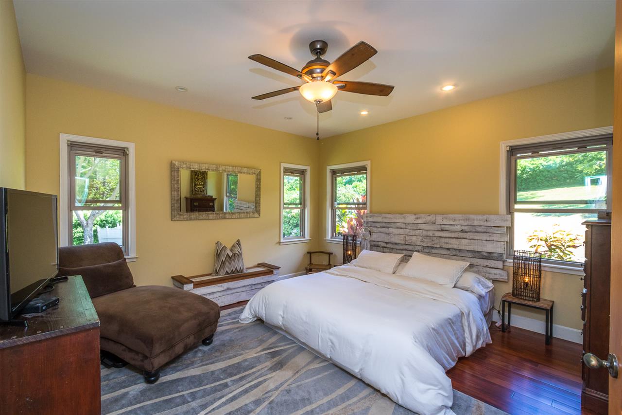 195 Mauu Place Haiku, HI 96708 - Photo 28 of 30 a bedroom with a bed and wooden floor