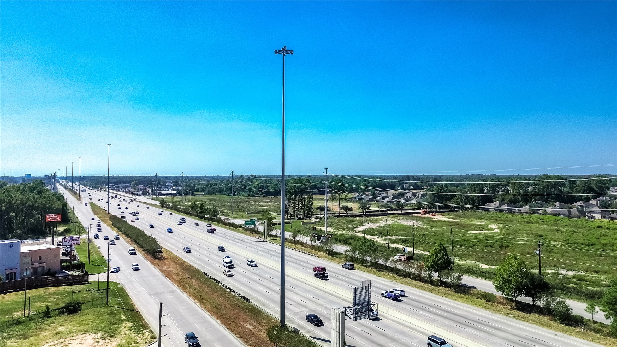 24255 Us Highway Porter, TX 77365 - Photo 21 of 24 a view of a large pool with lawn chairs under an umbrella