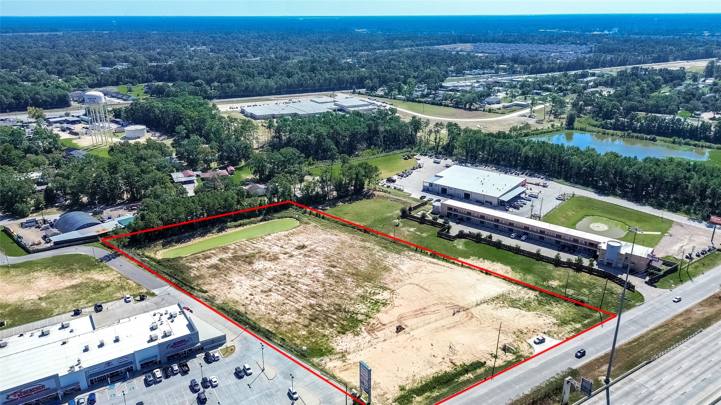 24255 Us Highway Porter, TX 77365 - Photo 3 of 24 an aerial view of a house with a garden and lake view
